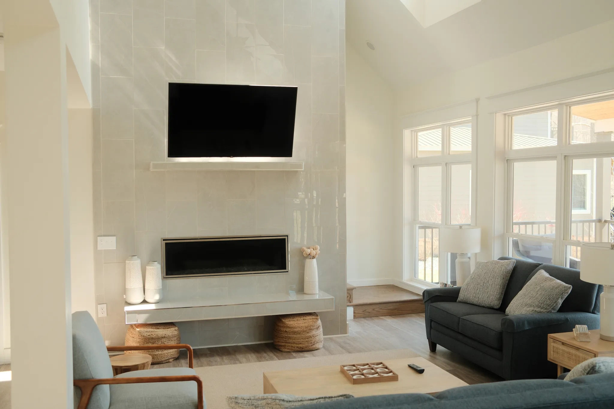 image Bright, airy living room with vaulted ceilings and soft seating invites relaxed gatherings and lakeside lounging.