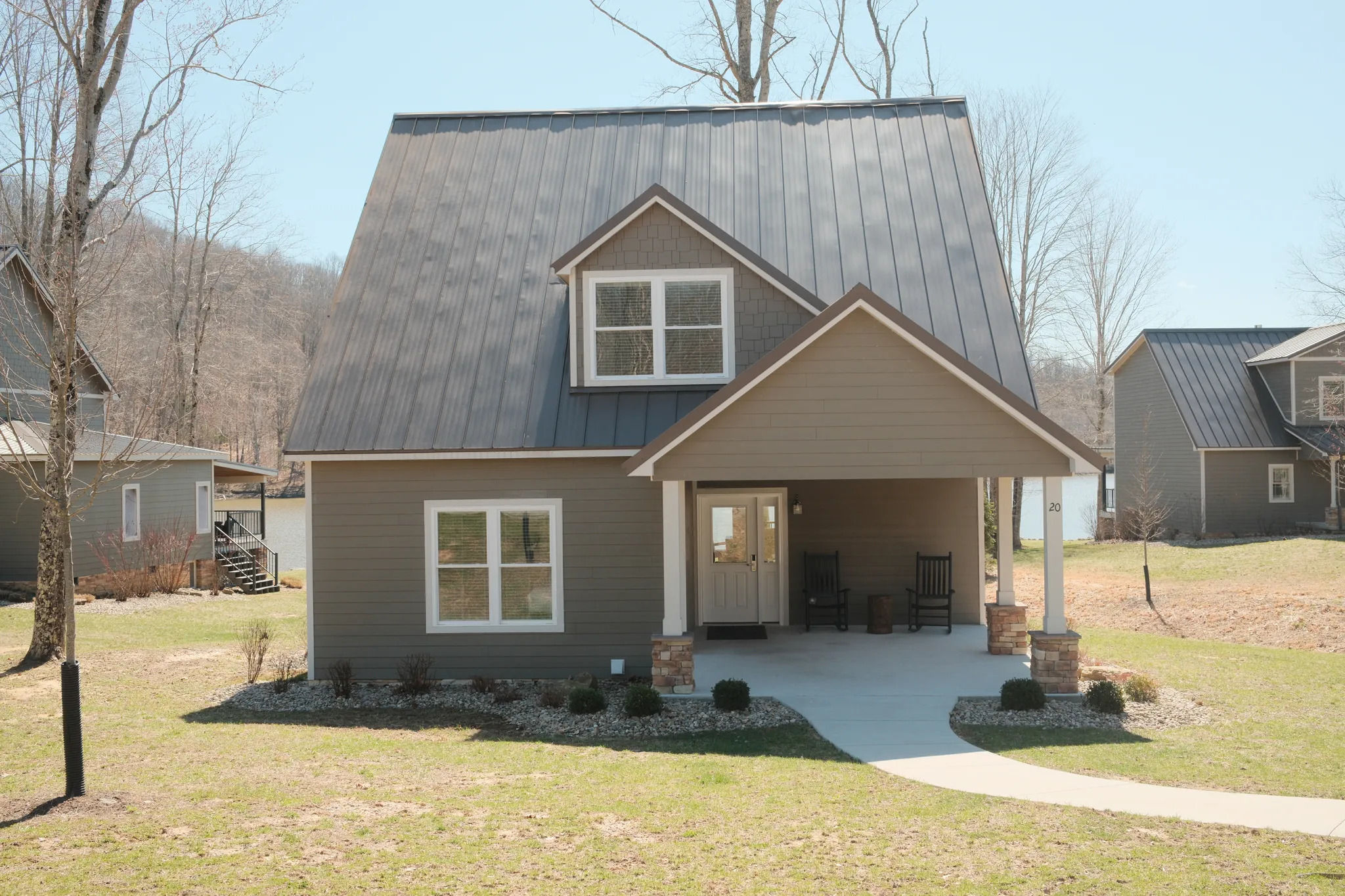 image Modern exterior with a charming front porch sets the stage for a peaceful stay in the hills.