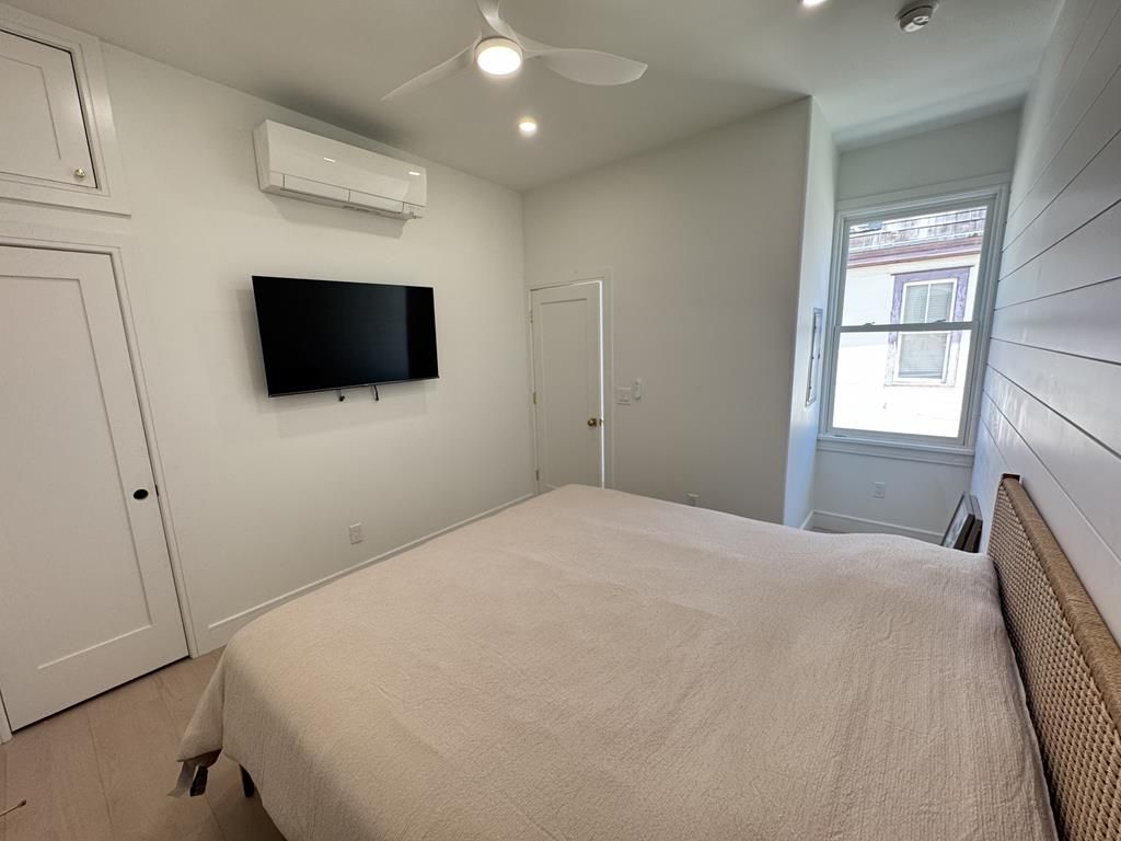 image Inviting king bedroom with stylish decor, plush bedding, and wardrobe storage.