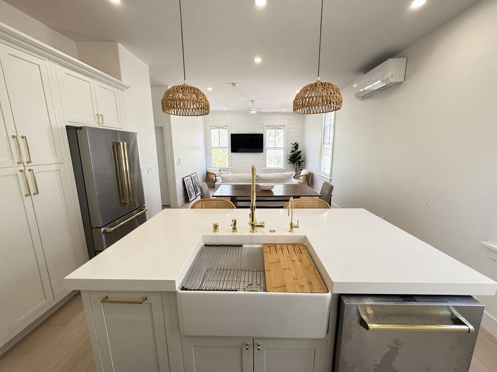 image Central island with farmhouse sink, perfect for prepping meals or casual dining.