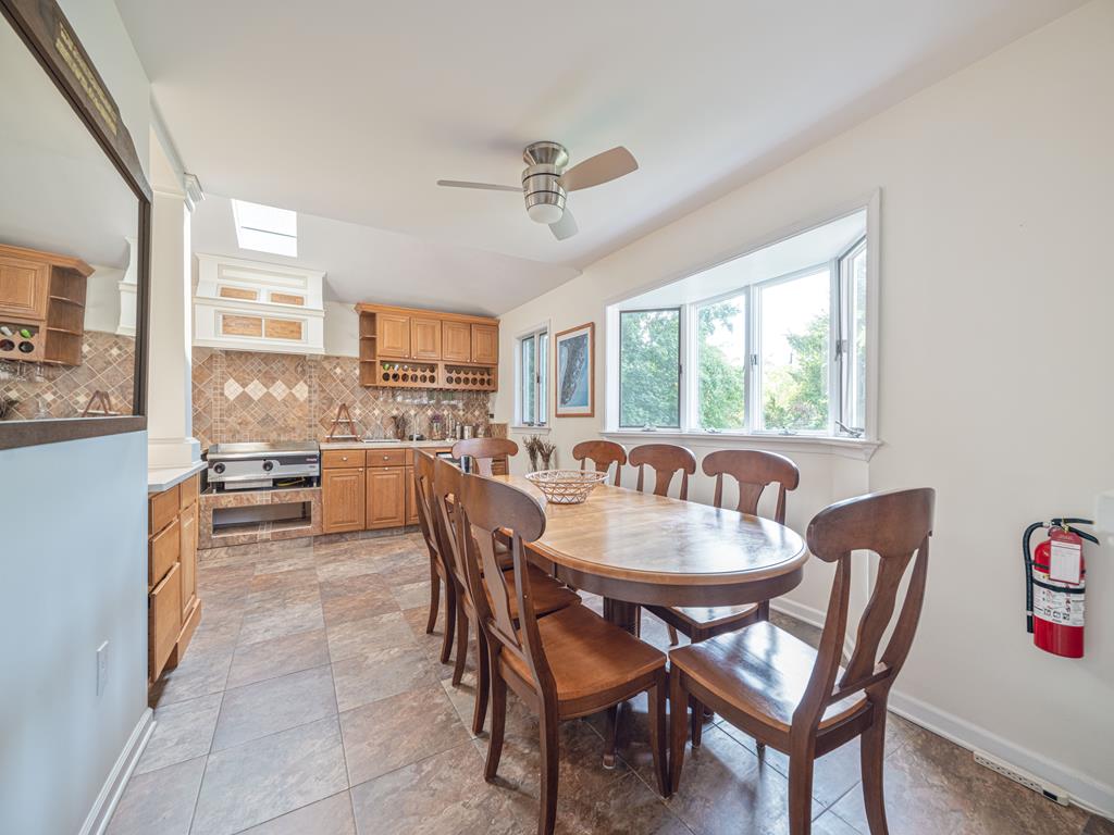 image This bright kitchen offers a seamless flow into the dining space, equipped with modern appliances and a layout that facilitates family gatherings and entertaining guests.