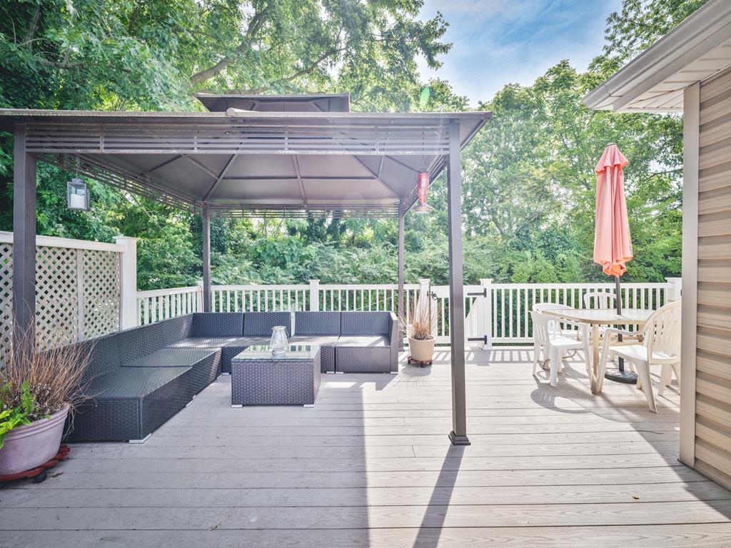 image The expansive deck offers a cozy outdoor seating area, ideal for family gatherings and entertaining guests.