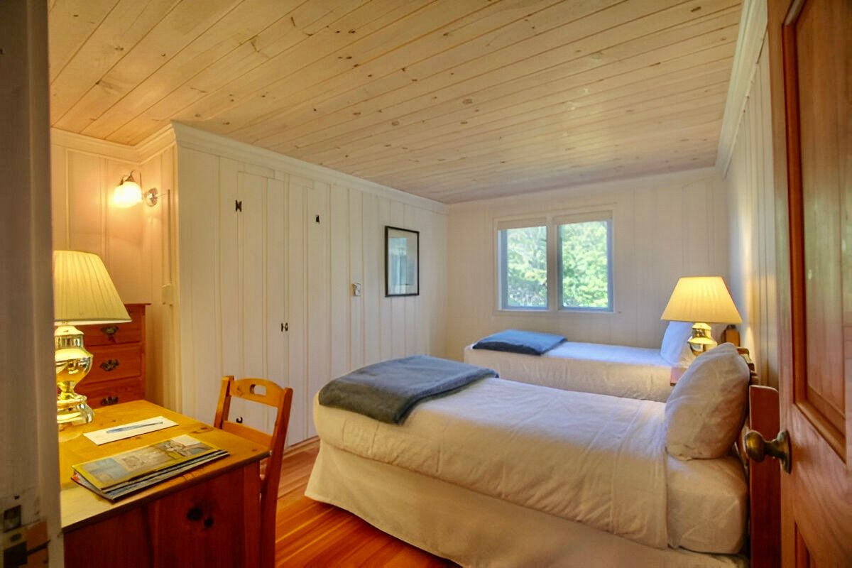 image Drift off beneath pinewood ceilings in a peaceful nook that captures the quiet soul of a Maine escape.