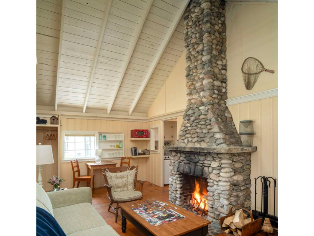 image Gather by the crackling hearth under vaulted ceilings in a cozy space that feels both rustic and refined.