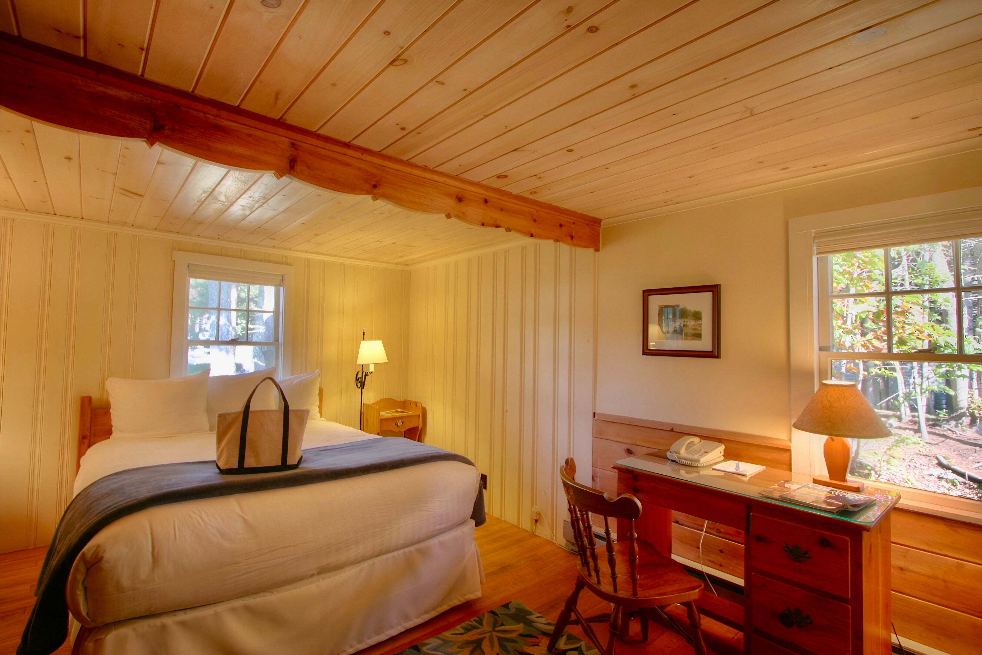 image Soft lamplight and vintage charm wrap you in comfort for a peaceful night in this storybook coastal retreat.