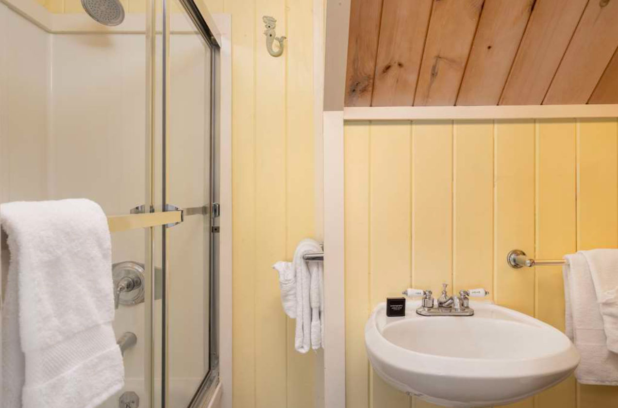 image Cozy and cheerful, this cottage-style bath offers a refreshing start with its warm hues and classic simplicity.