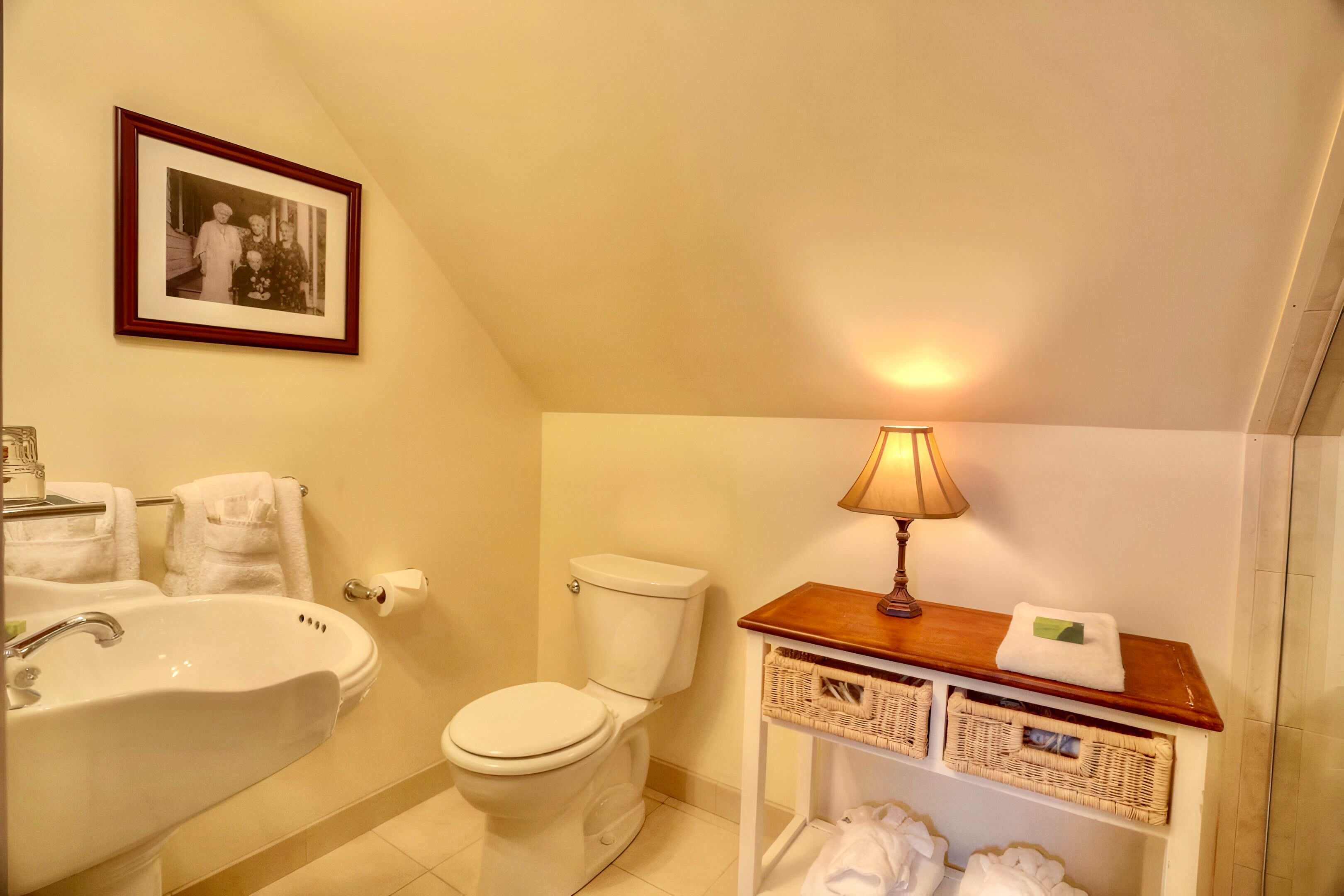 image Warm lighting and thoughtful touches make this petite bath a cozy space to reset and refresh.
