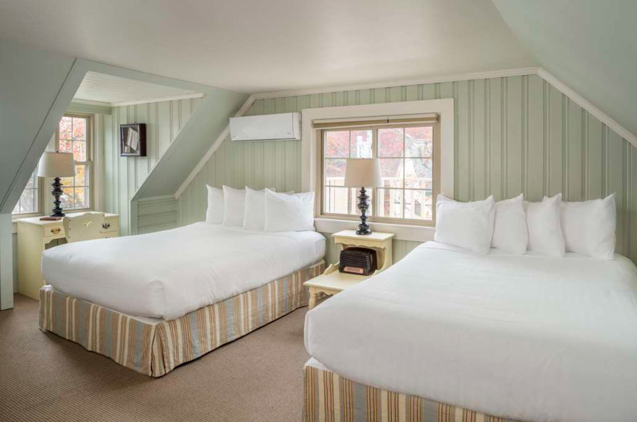 image Tucked beneath the eaves, this light-filled room blends breezy comfort with quiet charm for a restful retreat.
