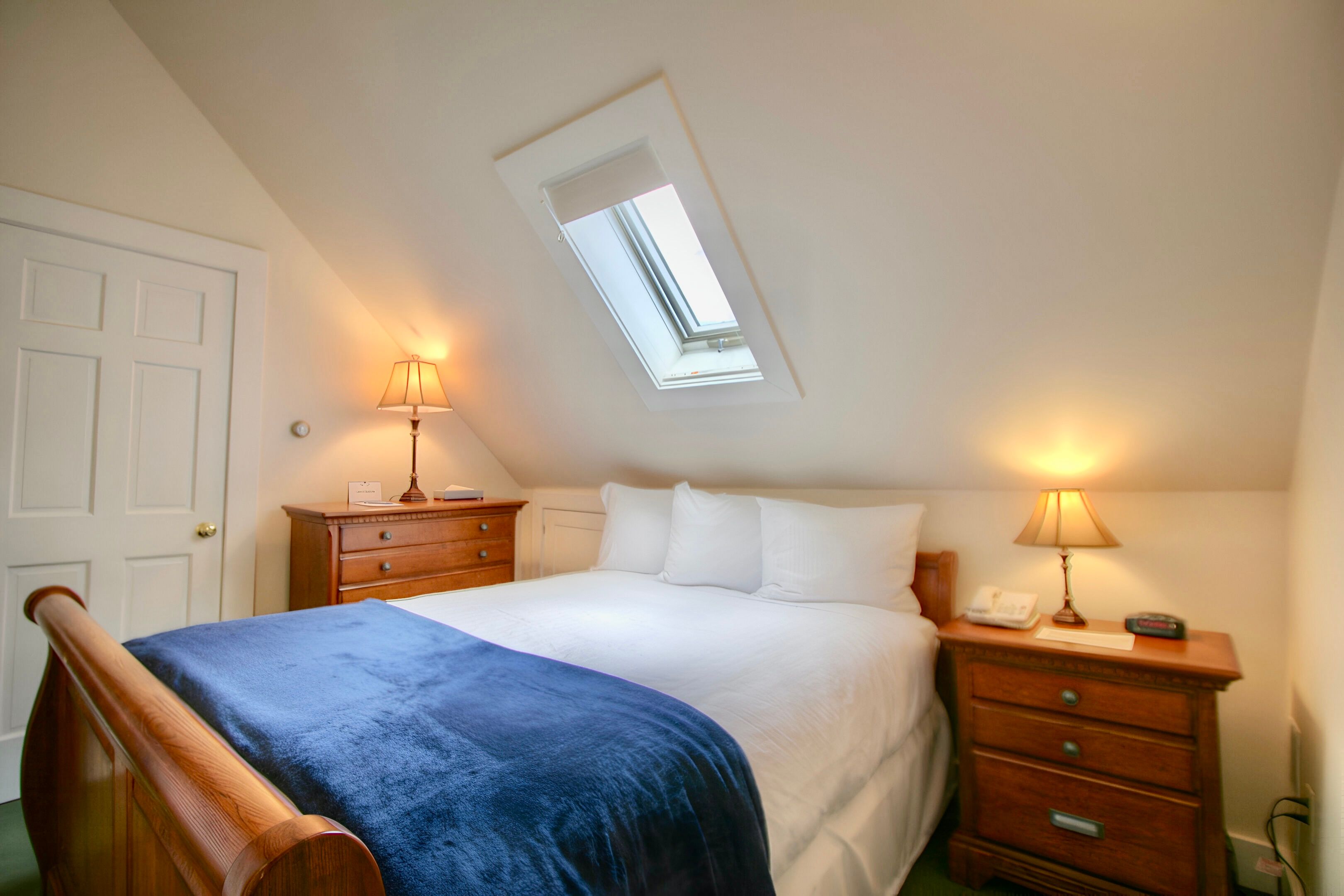 image Tucked under the eaves, this cozy bedroom glows with soft light and the promise of a restful night.