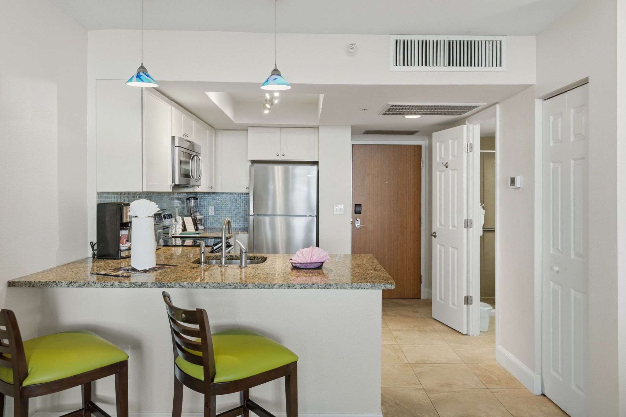 image Kitchenette with bar seating and cabinetry