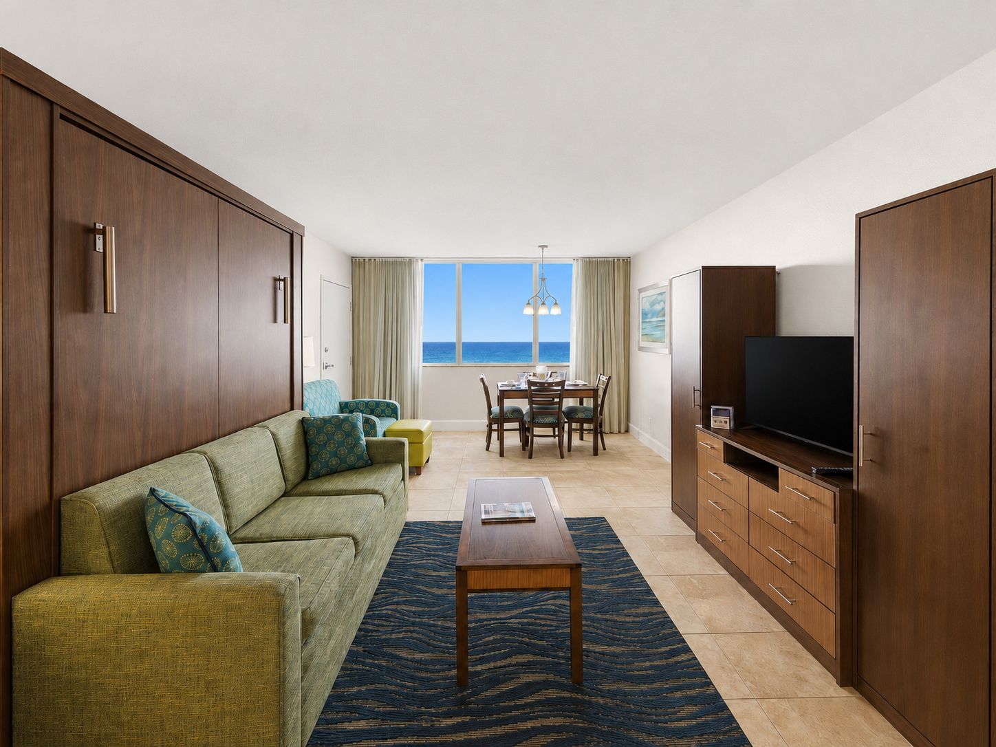 image Studio living area with sofa, table, and ocean views