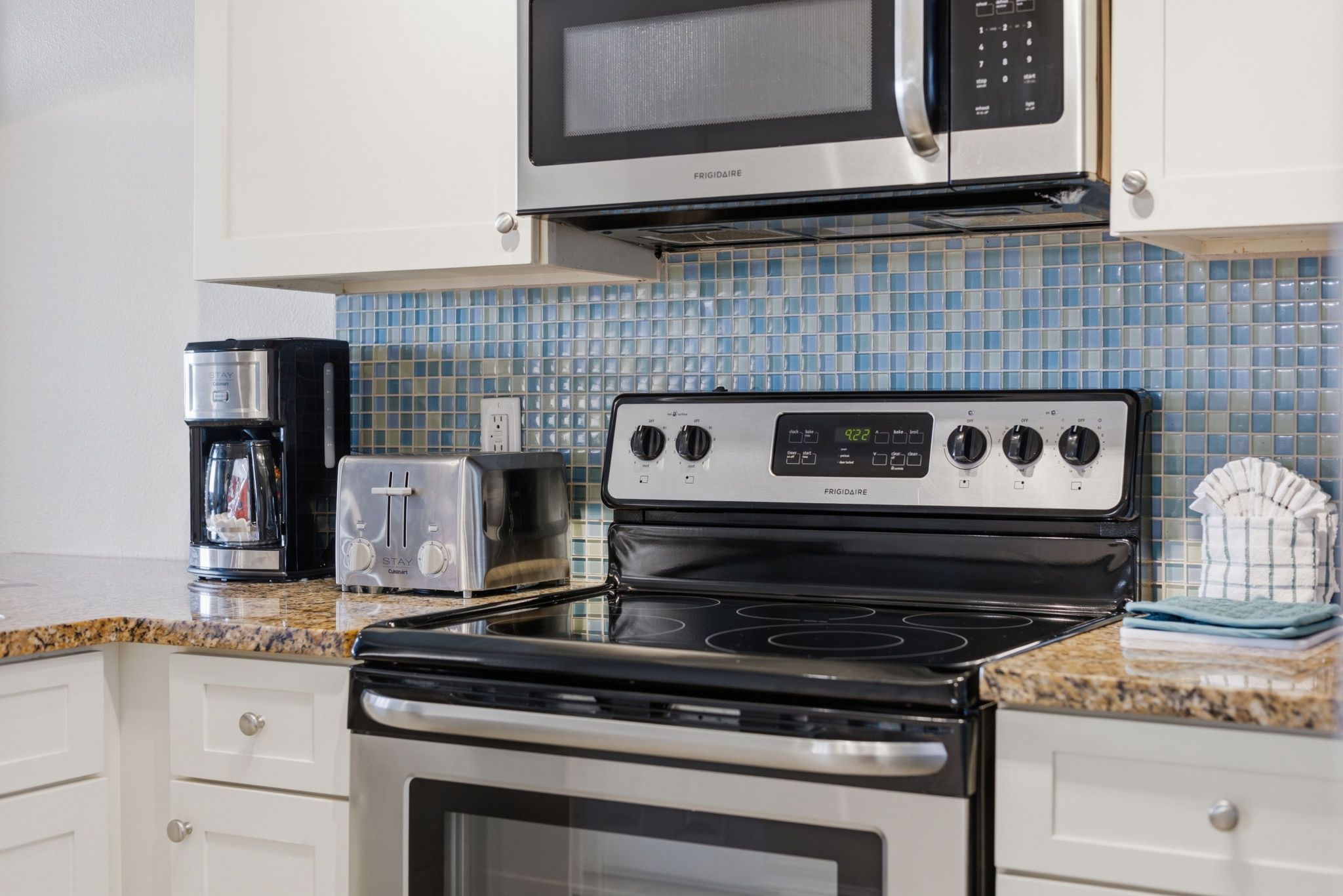 image Kitchenette with stovetop, microwave, and coffee maker