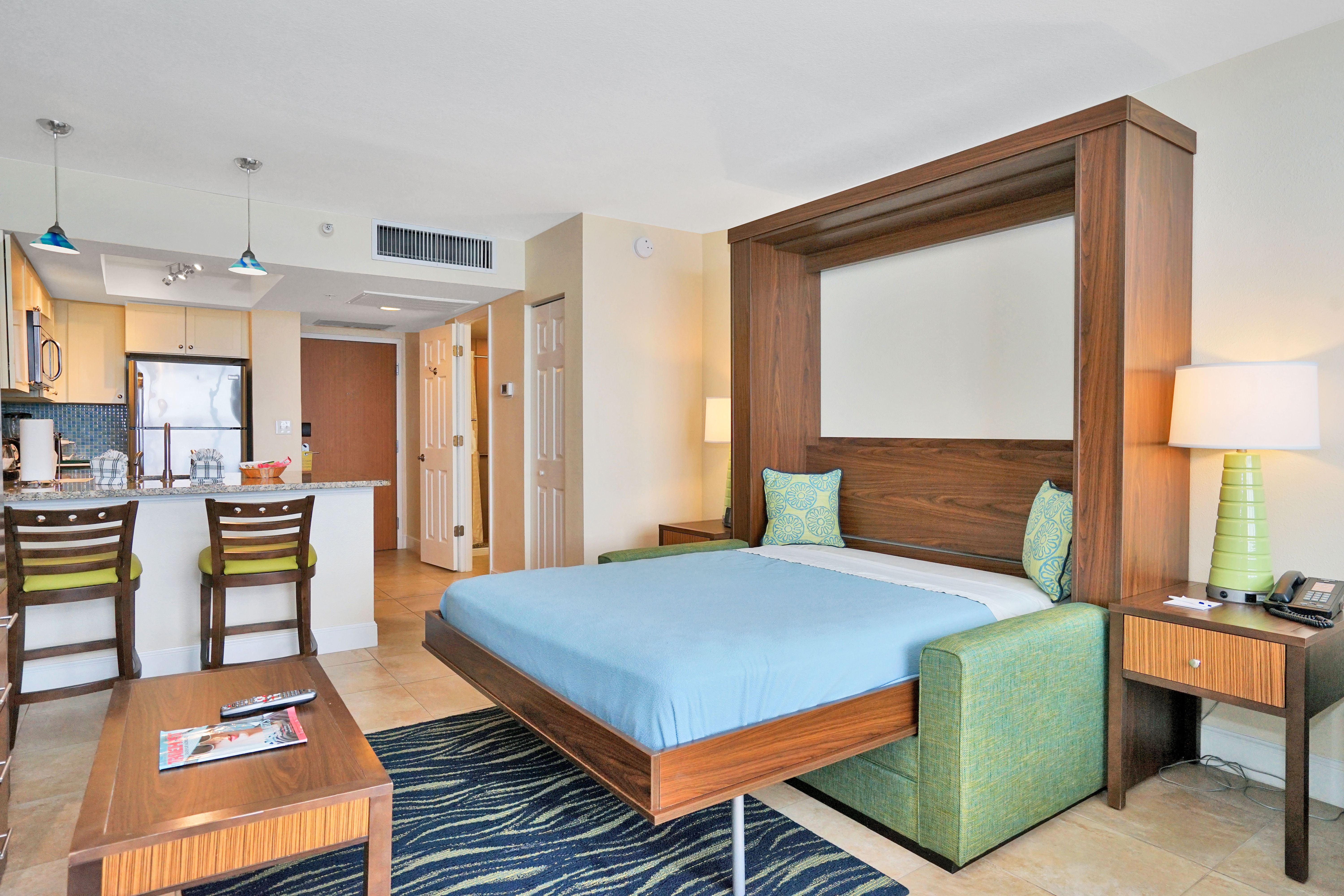 image Murphy Bed: A multifunctional space with a Murphy bed and comfortable living area setup.