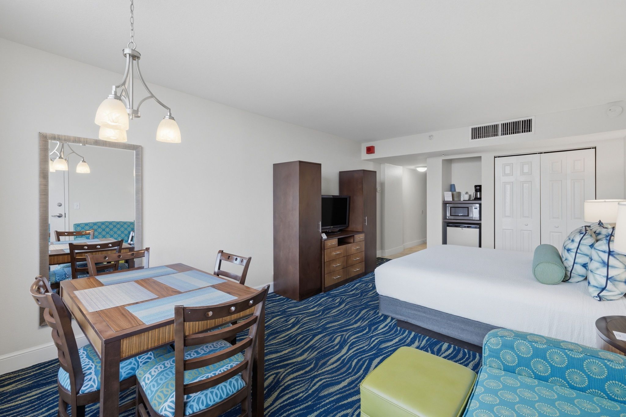image Studio unit with dining area, kitchenette, and television