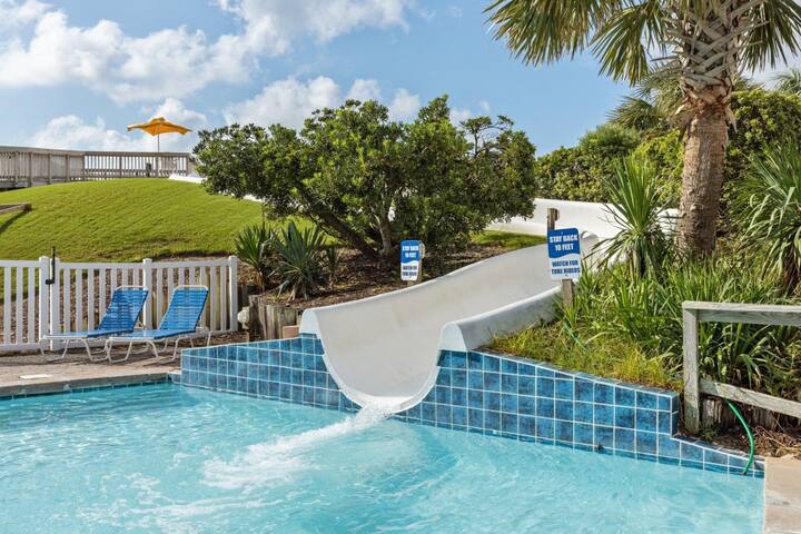 image Dive into fun with a thrilling water slide at the pool, perfect for kids and adults alike on a warm sunny day.