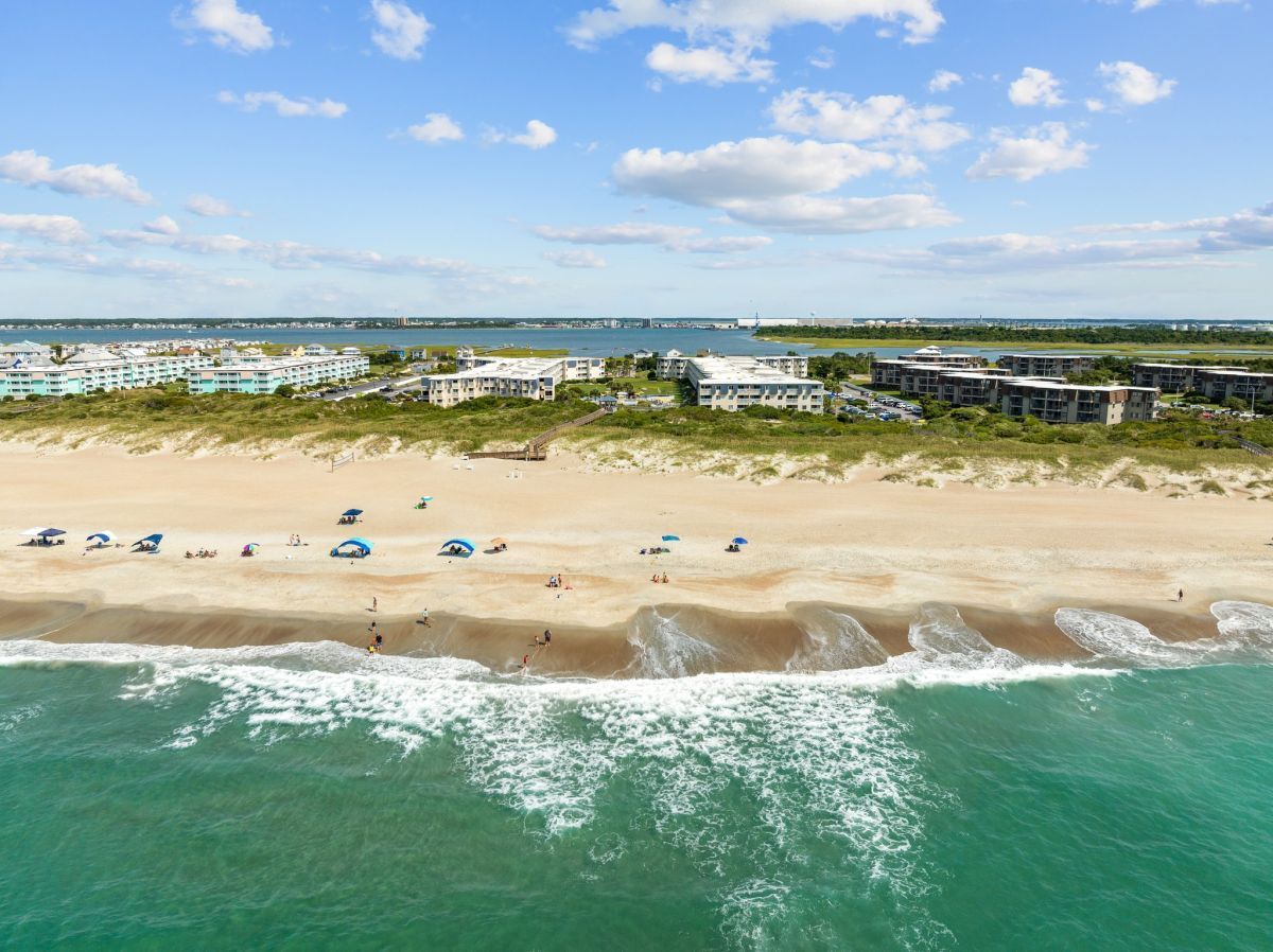 image Experience the ultimate beachfront getaway with direct access to sandy shores, stunning ocean and sound views, and proximity to Fort Macon and Morehead City.