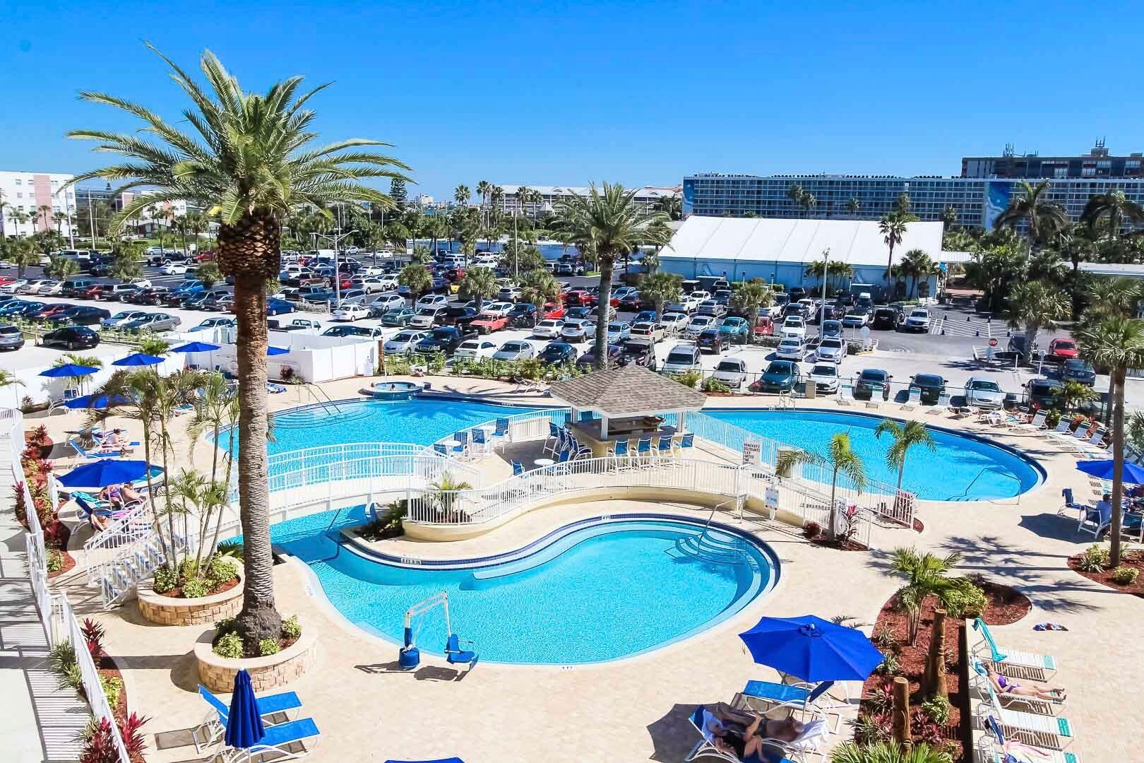 image Embrace the lush palm surroundings of the shared pool facilities, offering a refreshing retreat with beach access.