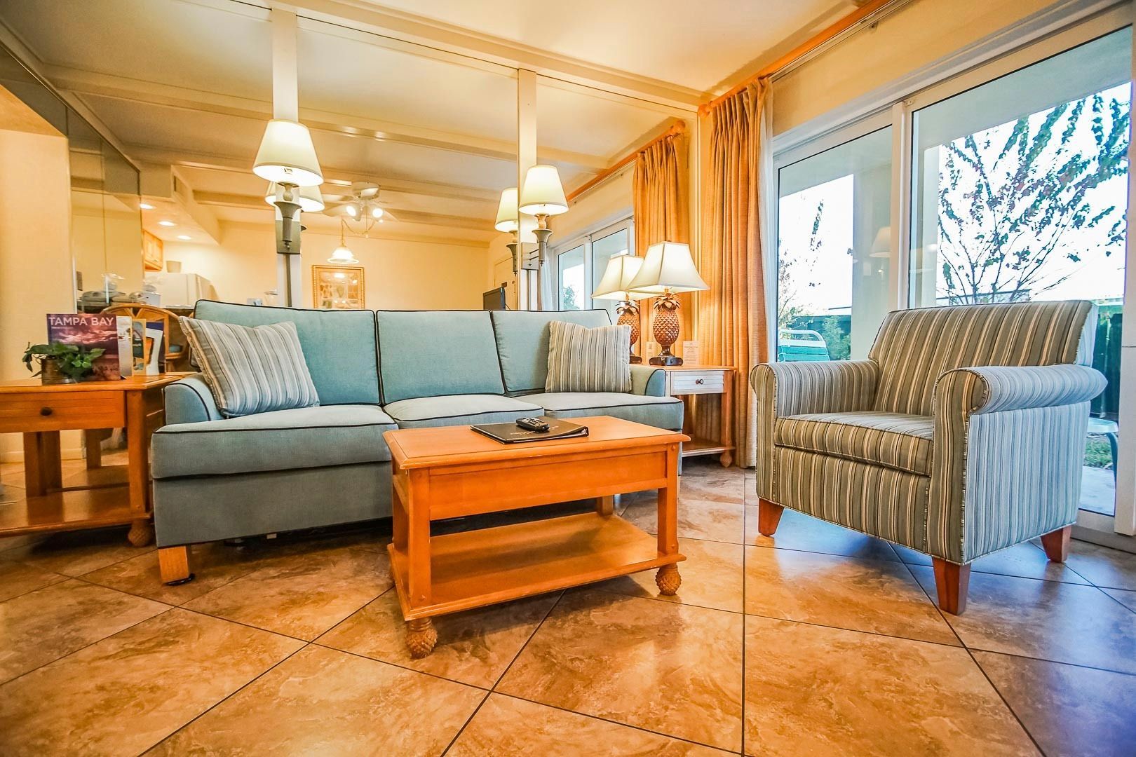 image Relax in the cozy living room, complete with a sofa bed, tasteful décor, and natural light flowing from large windows.