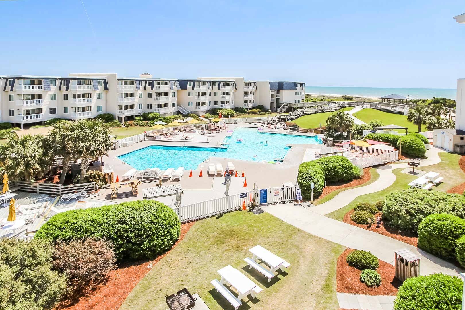 image Enjoy breathtaking ocean views from the pool area, complemented by a lush, landscaped environment and a spacious family layout designed for comfort and relaxation near Fort Macon and Morehead City.