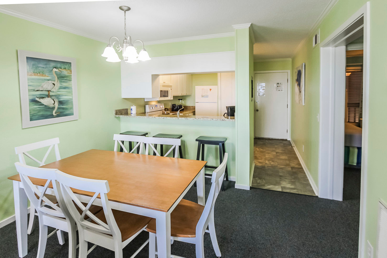 image A cozy and well-equipped dining area and kitchen provide a welcoming space for family meals and gatherings.