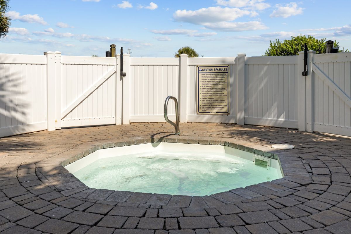 image Relax in the serene hot tub area, enclosed for privacy, offering a peaceful retreat after a day of fun under the sun.
