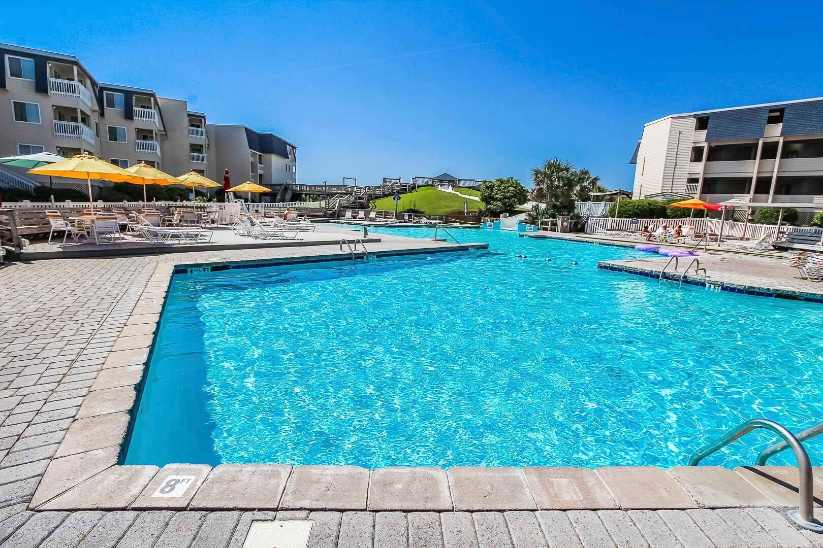 image Dive into relaxation with shimmering indoor/outdoor pools, a soothing hot tub, and easy access to the beach, all complemented by a full kitchen for effortless dining after a day of adventure near Fort Macon.