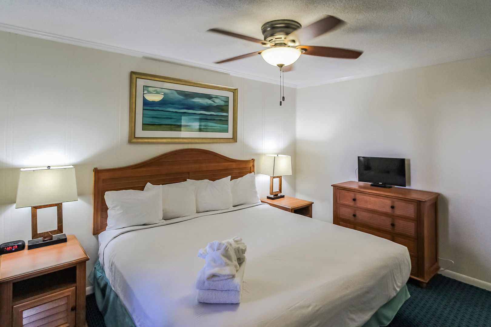 image Retreat to a cozy bedroom featuring convenient amenities and a calming ambiance, making it a perfect place to relax after a day of exploring nearby attractions like Fort Macon.