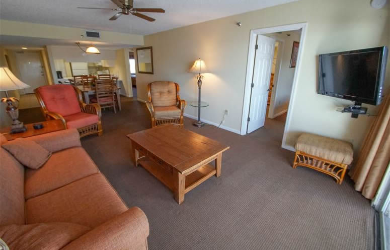 image This inviting living space is designed for comfort, featuring a smart TV and easy access to a full kitchen and dining area, making it a perfect home away from home.