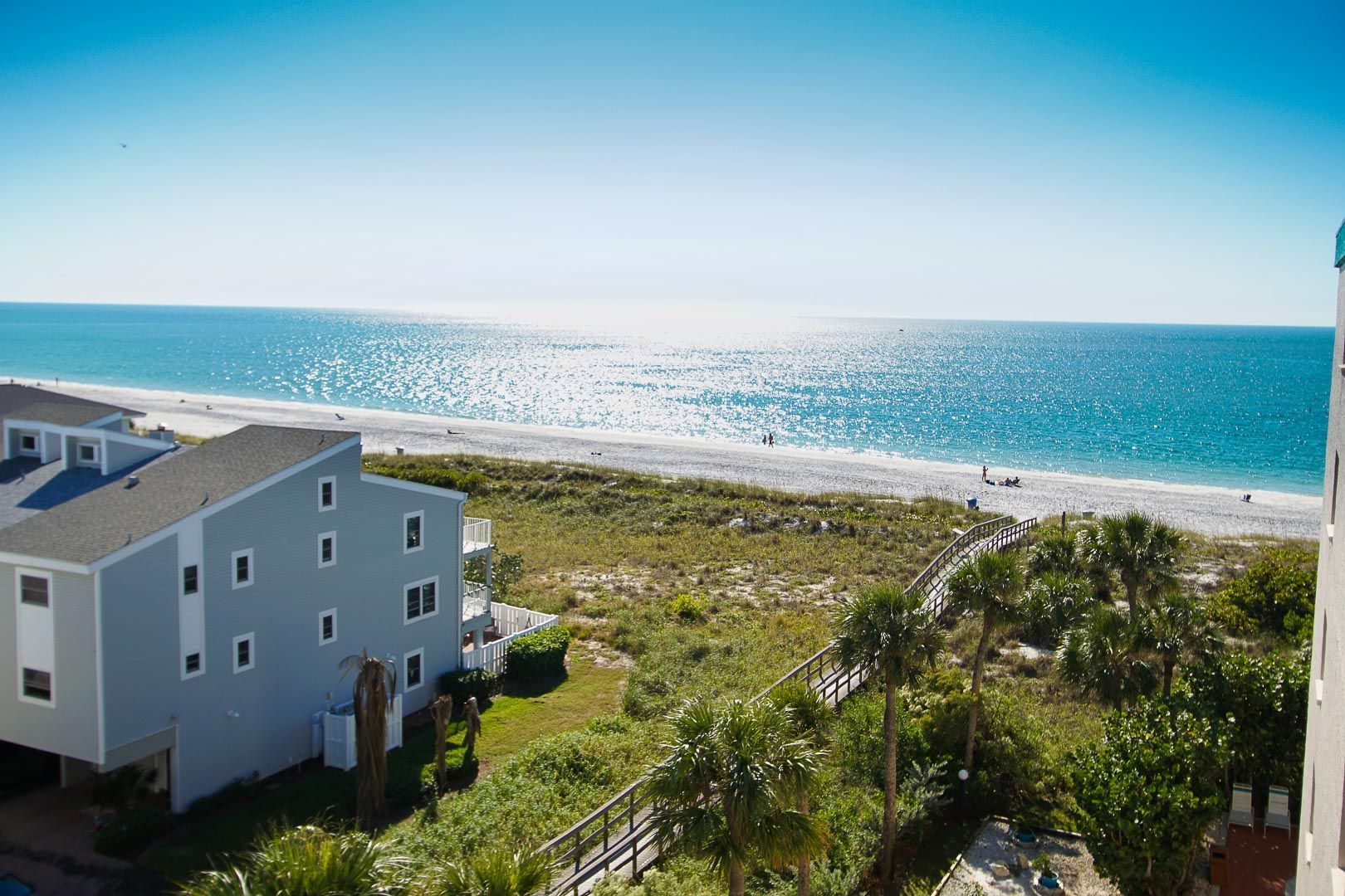 image Relax in comfort with two full-size beds and a sleeper sofa available for extra guests in this cozy beachside getaway.