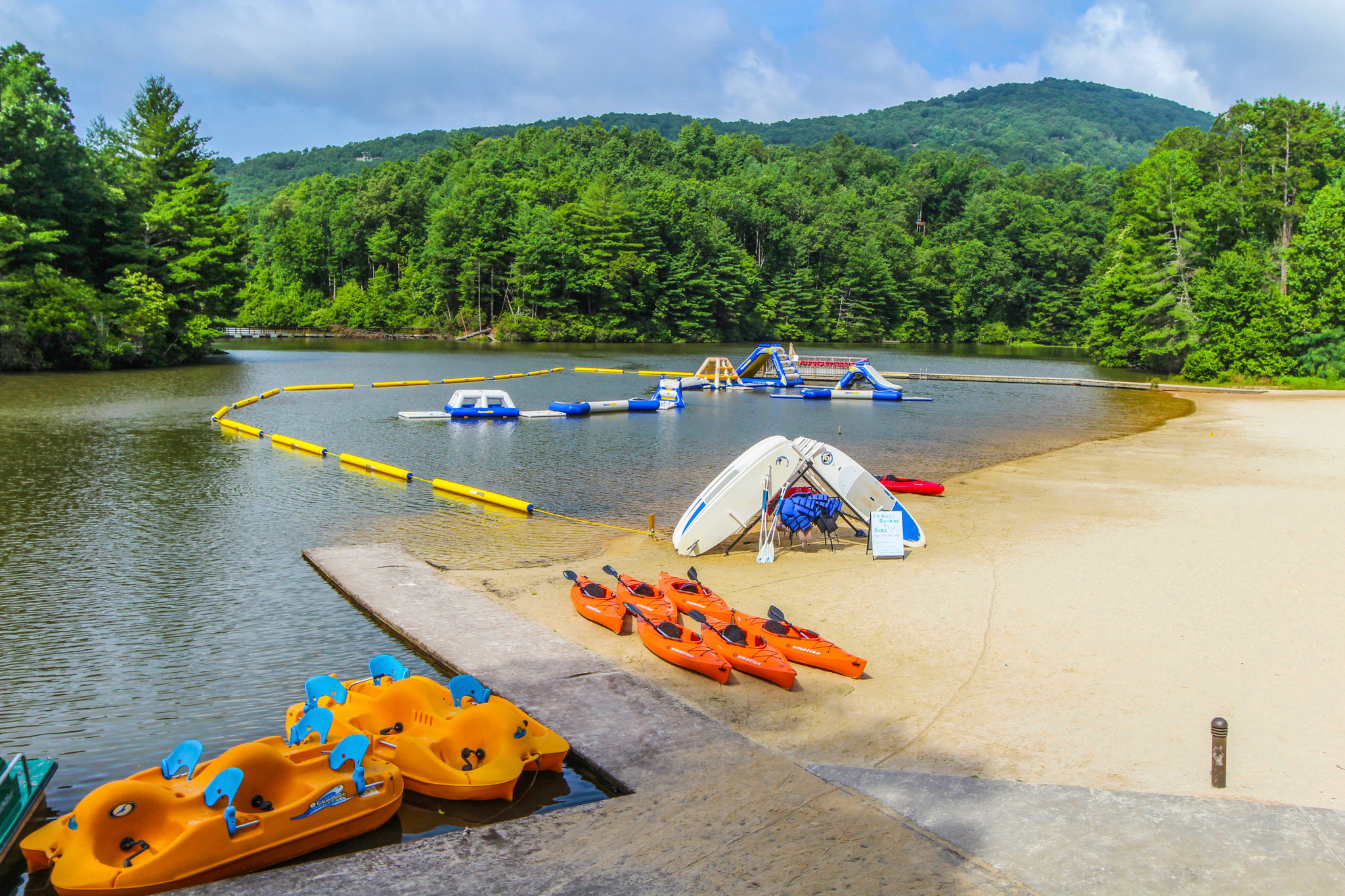 image Enjoy a fun-filled day at the nearby lake featuring water activities, including kayaks and inflatable play areas, ideal for families and friends.