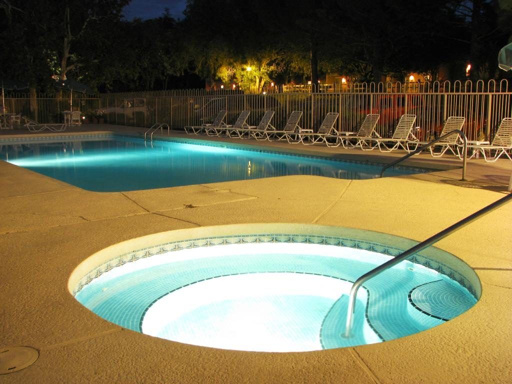 image Relax in the outdoor pool and soothing hot tub, surrounded by inviting lounge chairs in a tranquil Sedona setting.