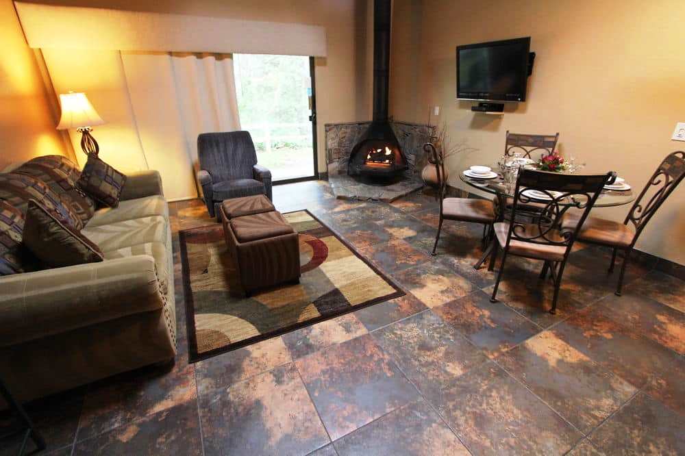 image A cozy living area featuring a gas fireplace and dining space, inviting couples and families to relax in a warm, welcoming atmosphere.