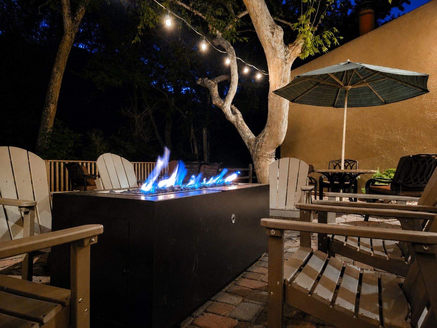 image A fire pit glows warmly, creating an inviting ambiance for evening gatherings outdoors.