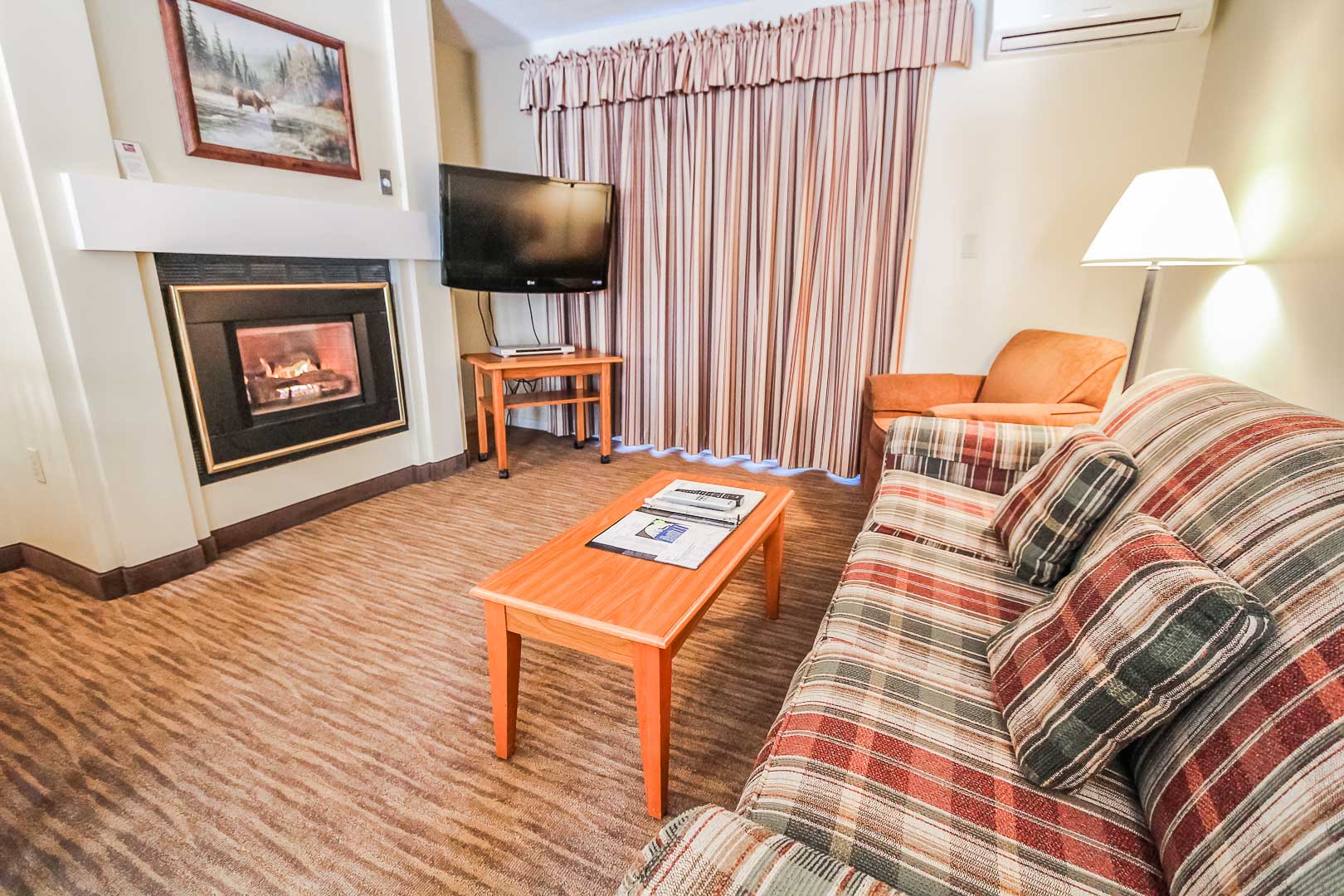 image Cozy up beside the fireplace in a charming living room that combines comfort and mountain-themed décor, ideal for relaxing after a day of adventure.