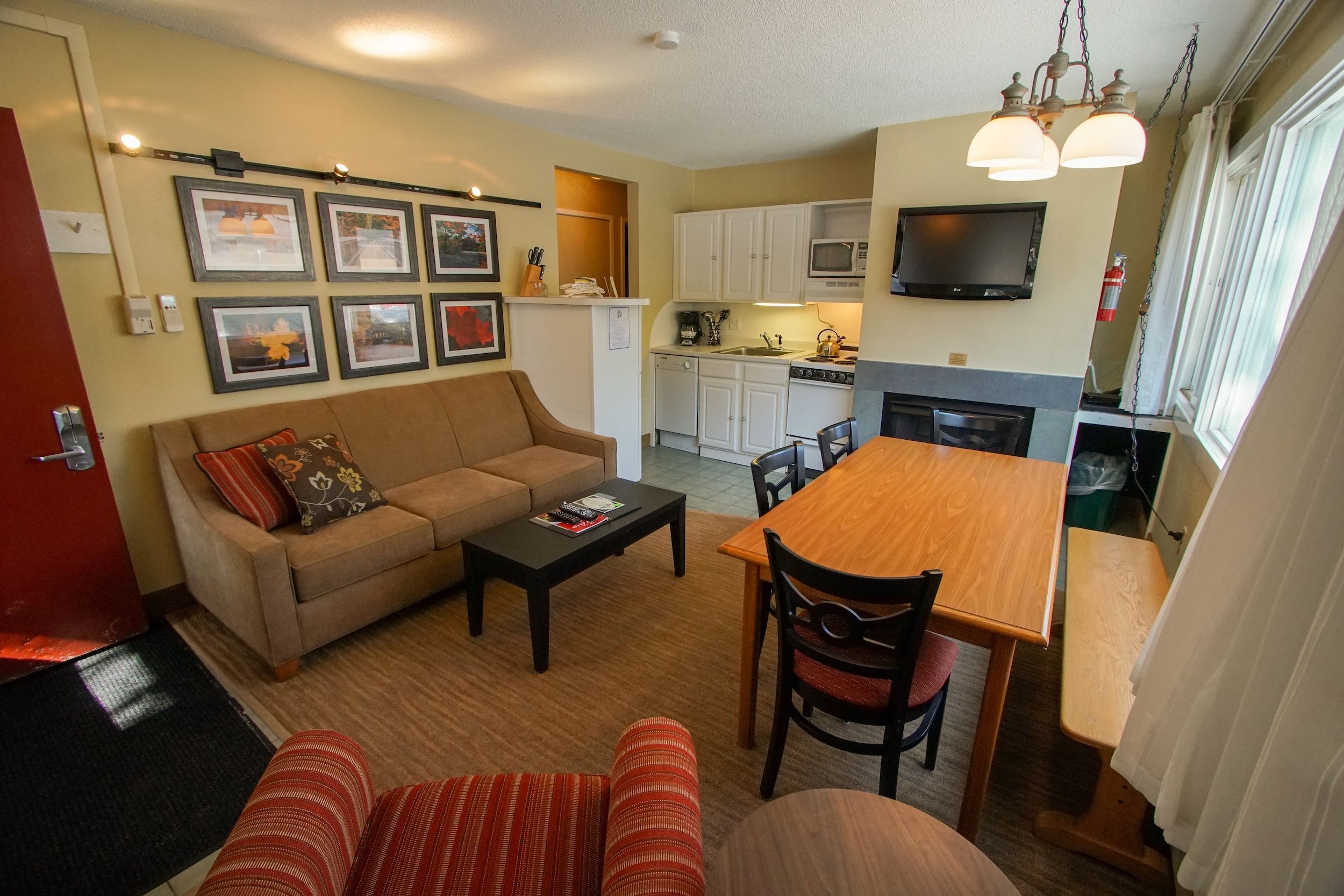 image Relax on the cozy couch, framed by charming artwork that captures the essence of mountain life.