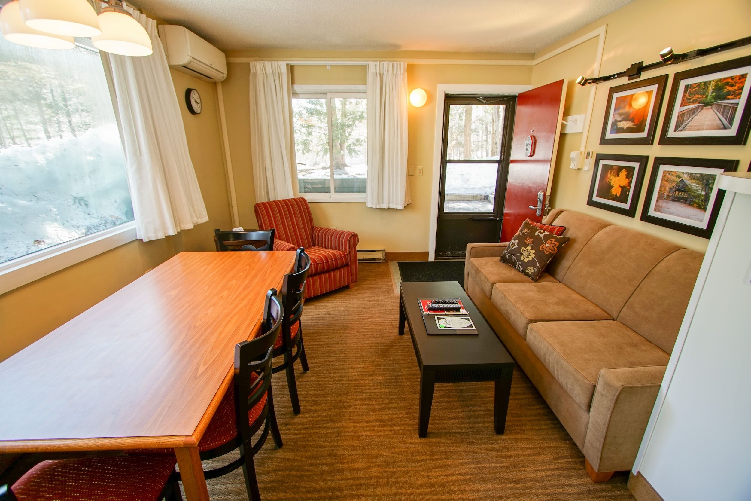 image Gather with friends in the living area, complete with a sofa and dining space for shared moments.