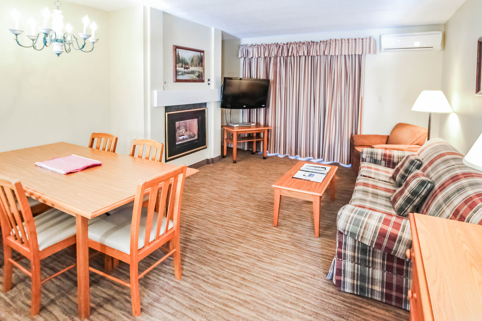 image Enjoy a warm and inviting living space with a fireplace lounge and dining area, perfect for family gatherings after a day of exploring the nearby White Mountains.
