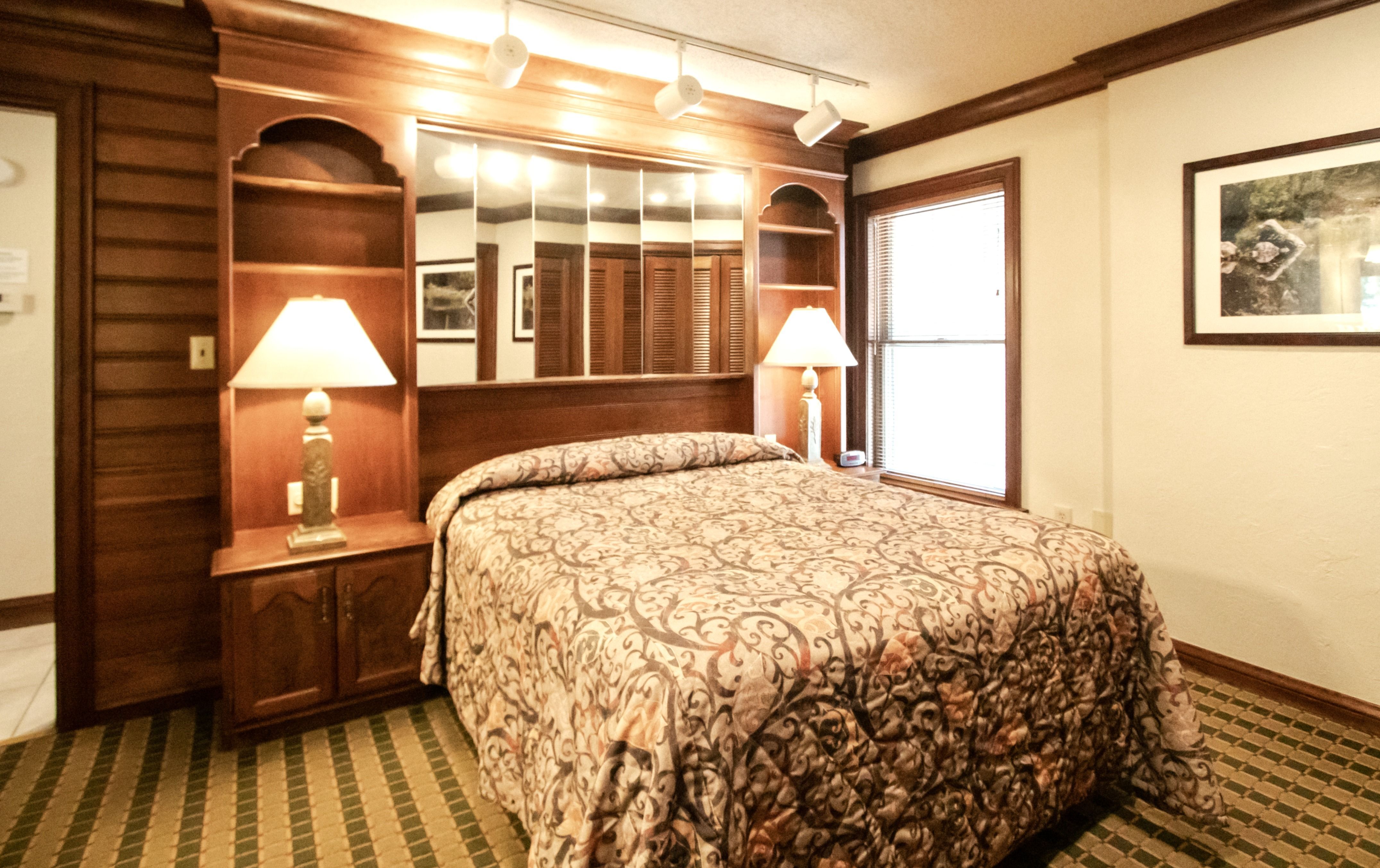 image Master bedroom offering a serene atmosphere with a plush bed, tasteful decor, and warm lighting.