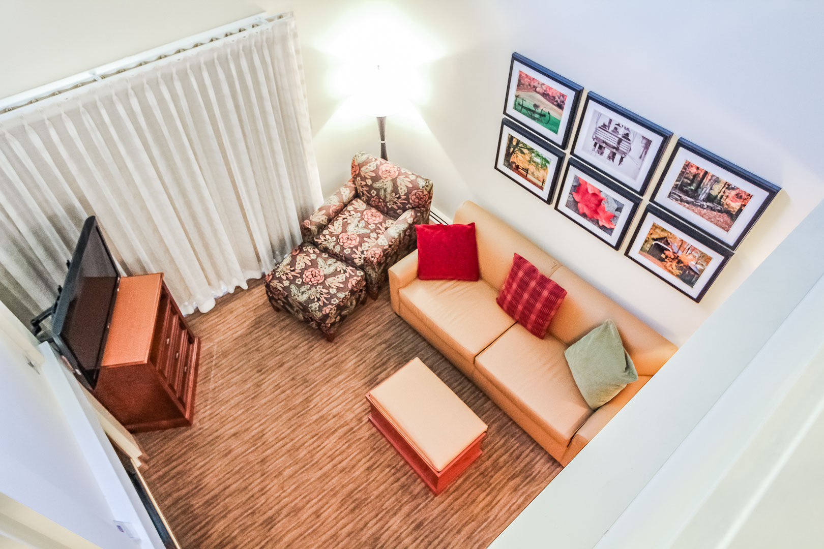 image This inviting loft features a comfortable seating area with decorative pillows, perfect for relaxing after a day of adventures in the White Mountains.
