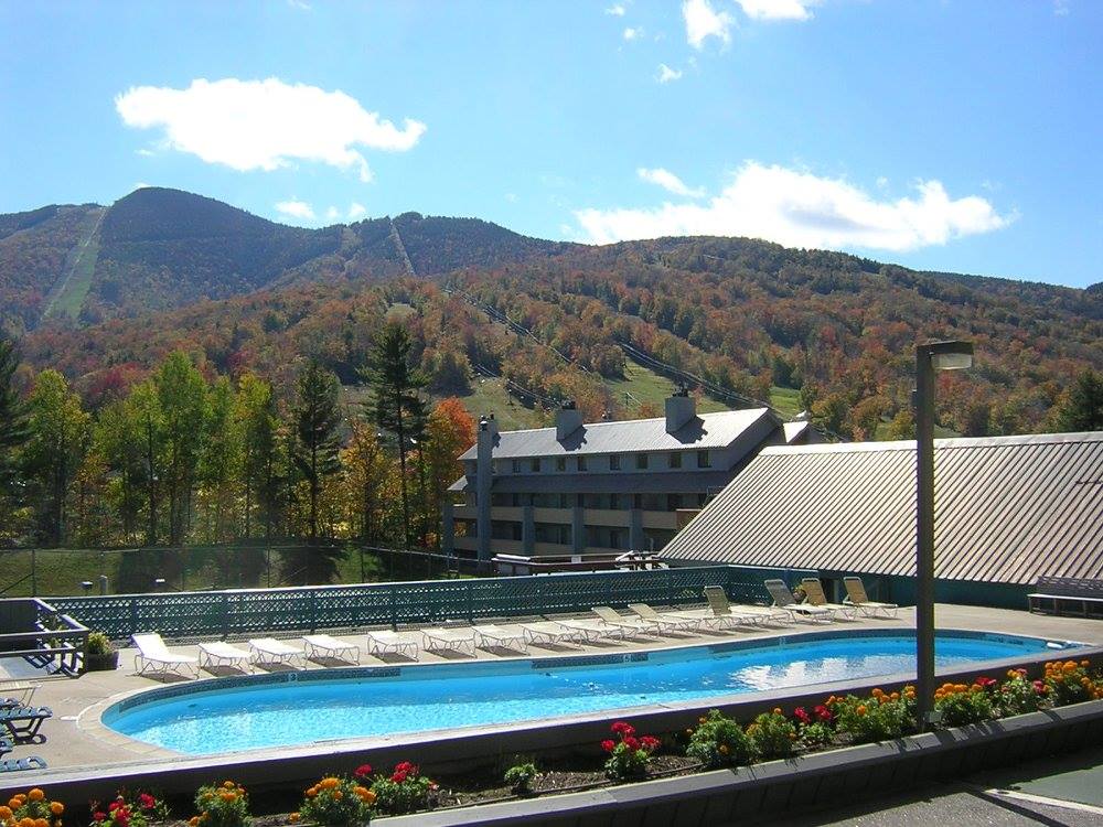 image Experience the beauty of the White Mountains while lounging by the outdoor pool, surrounded by vibrant fall foliage and majestic views.