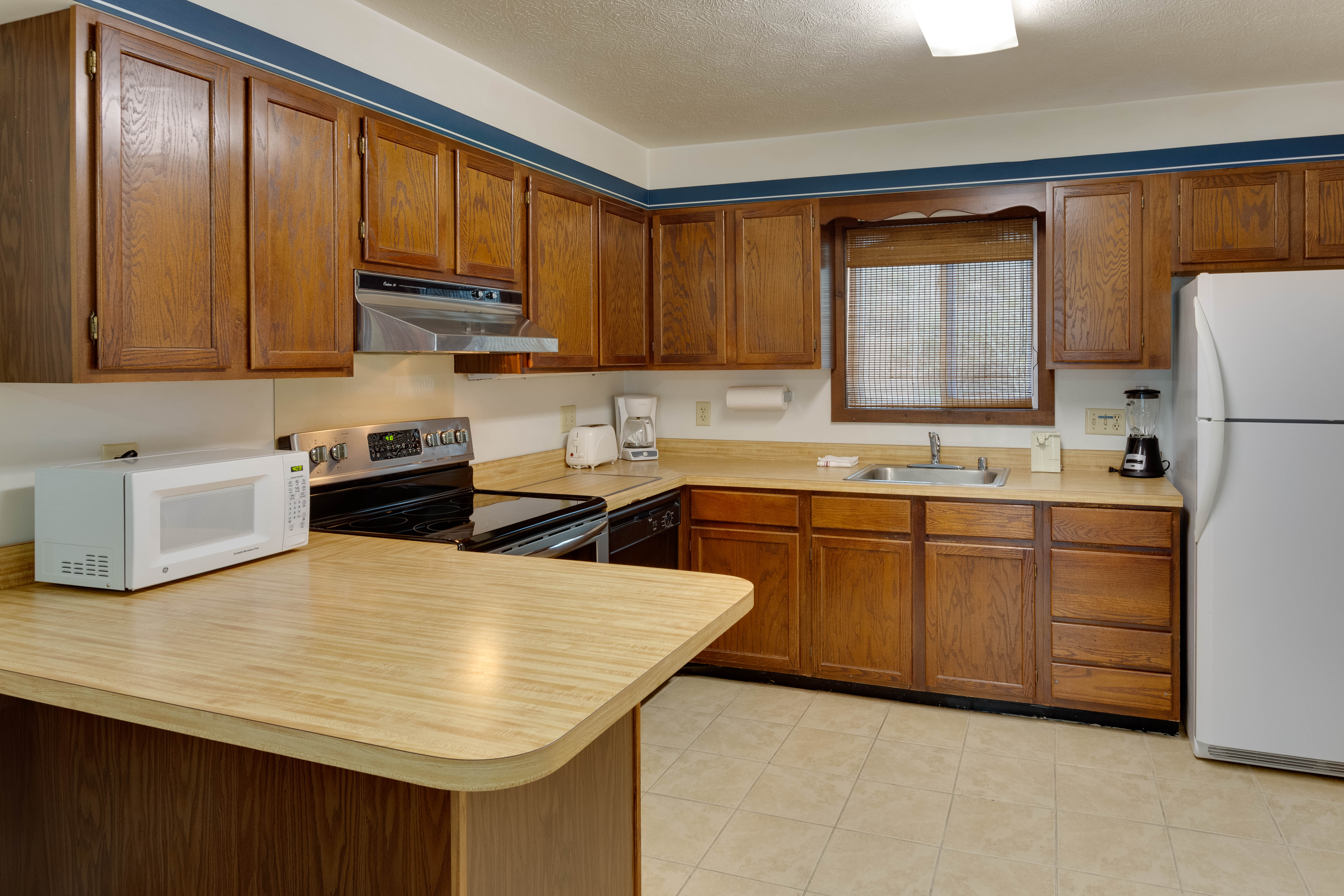image Fully equipped kitchen with ample counter space and modern appliances—ideal for cooking meals together.