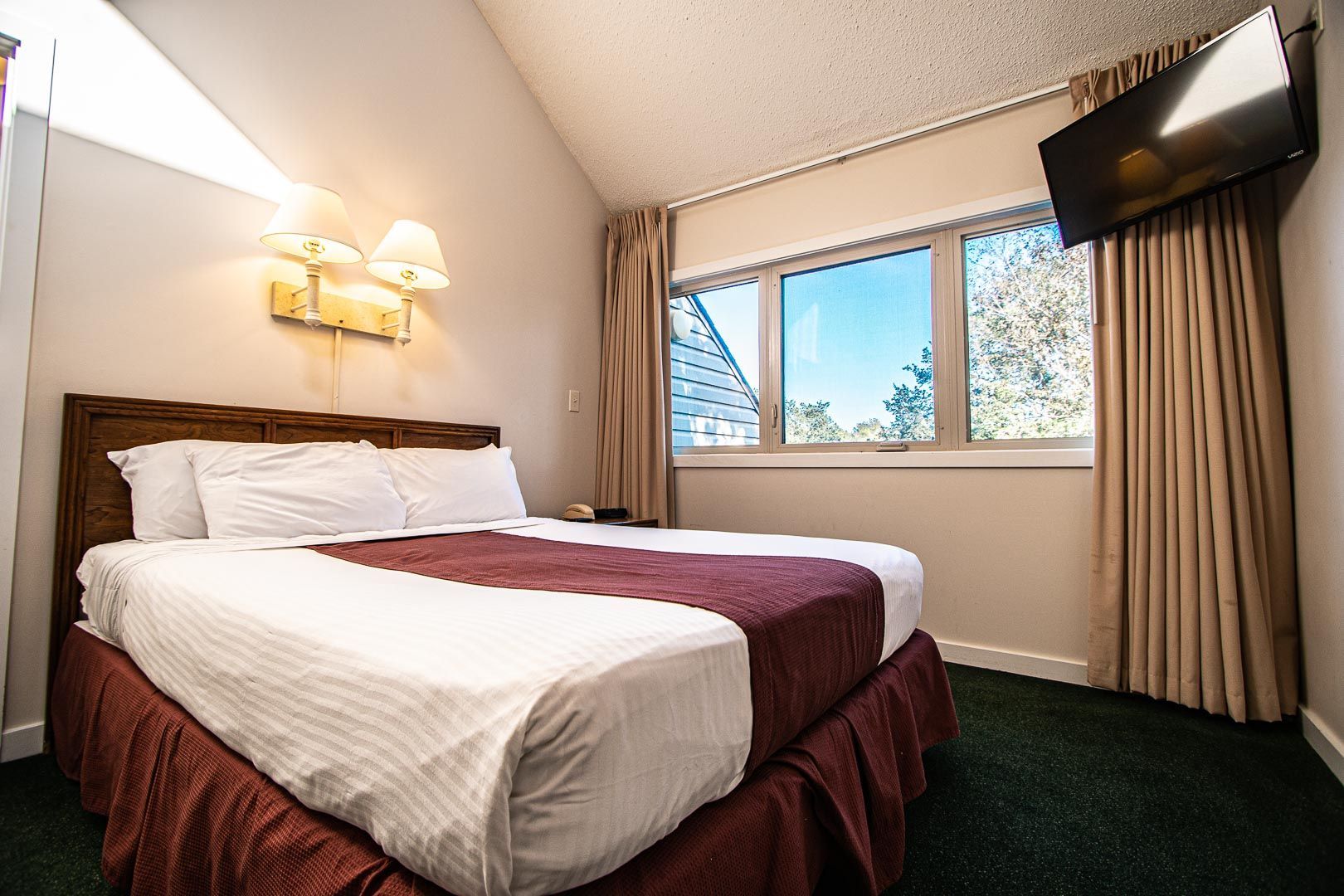 image This cozy bedroom features a queen bed, natural light from large windows, and modern decor, perfect for family relaxation after a day of fun.