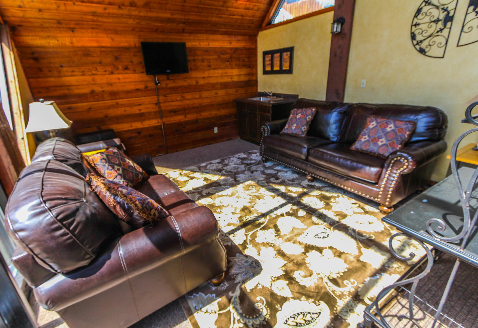 image Relax in the comfortable living area featuring plush seating and a flat-screen TV, ideal for family gatherings after a day on the slopes.