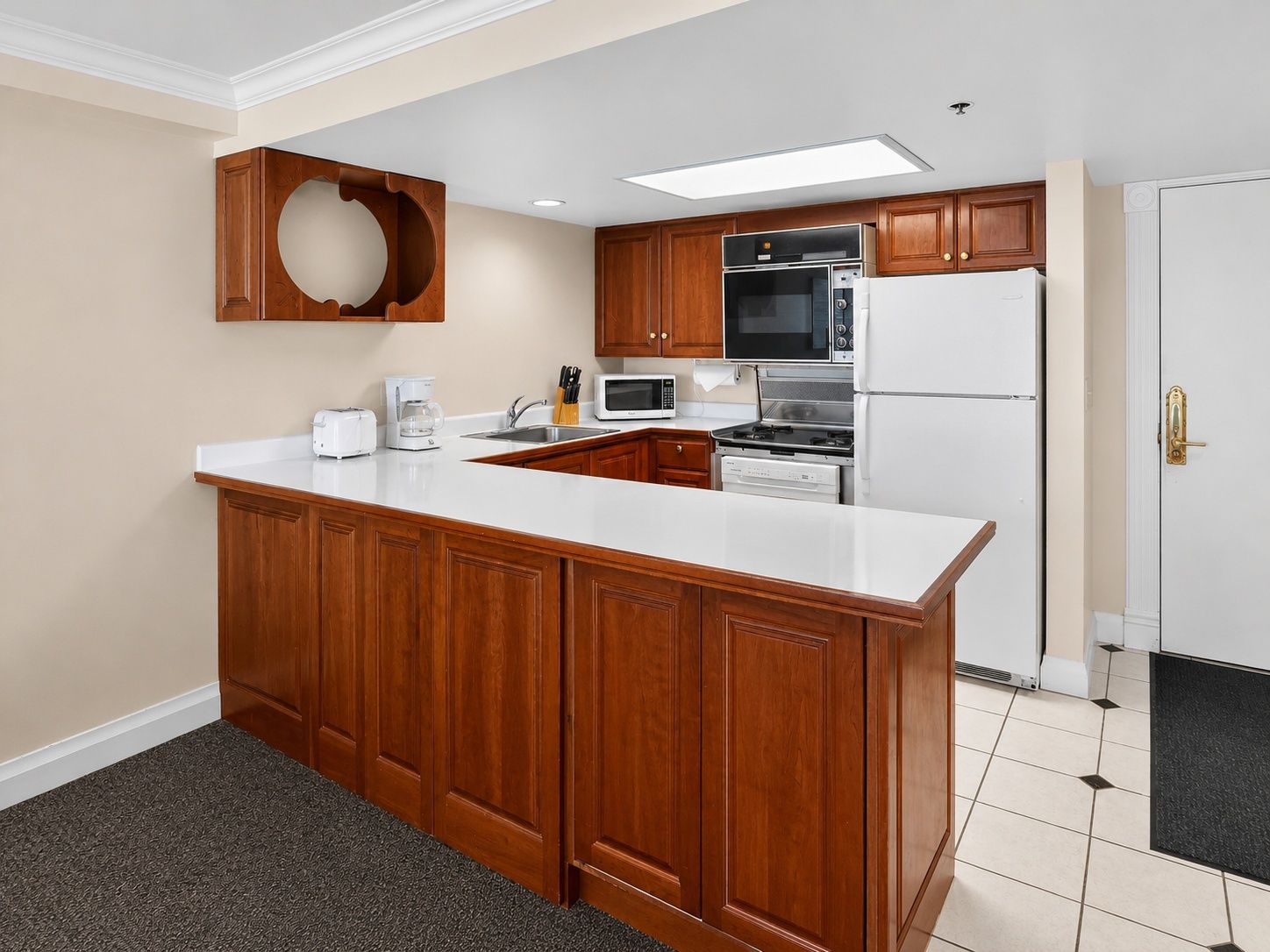 image Kitchen featuring cabinets, counter, and appliances.