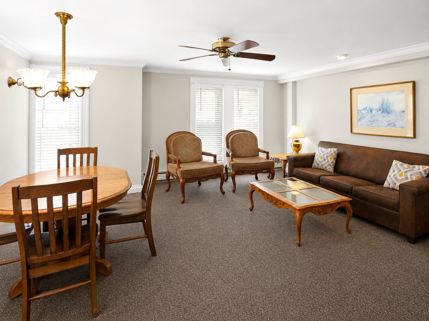 image Living area with a couch, chairs, and dining table.
