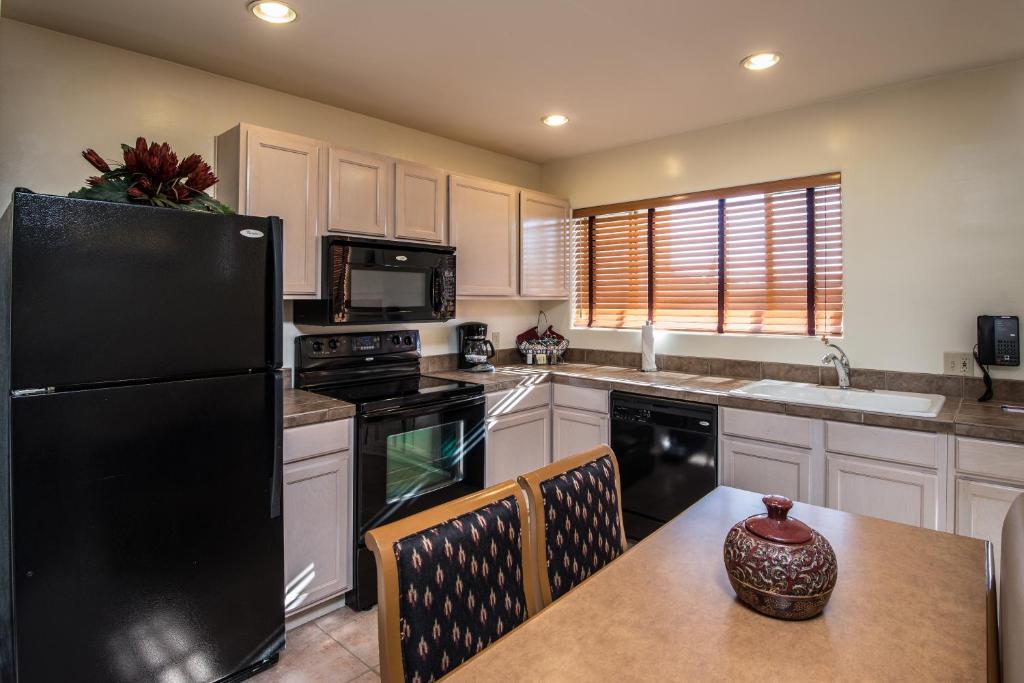 image This well-appointed kitchen features modern appliances and a cozy dining area, perfect for home-cooked meals in the heart of your two-story Arizona villa.
