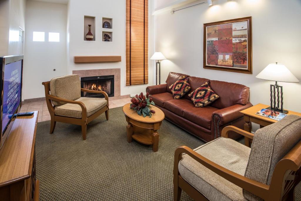 image This open-concept living area, complete with a fireplace and contemporary decor, provides a cozy space for family gatherings amidst the stunning backdrop of the Arizona landscape.