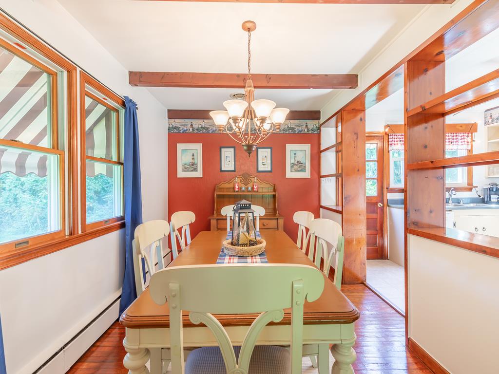 image Enjoy meals with family and friends in this delightful dining area, complete with ample natural light and a serene view of the fenced yard.