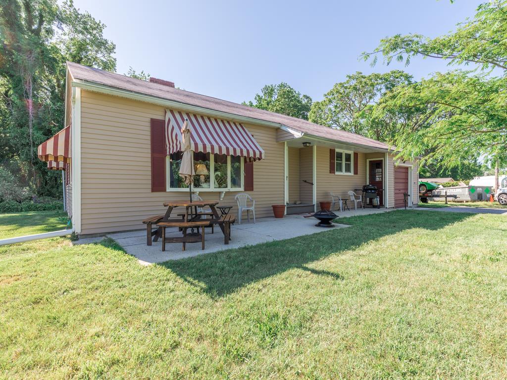 image Enjoy the perfect pet-friendly retreat with stunning wildlife pond views from this charming Cape May home, complete with a fenced yard and inviting outdoor seating.