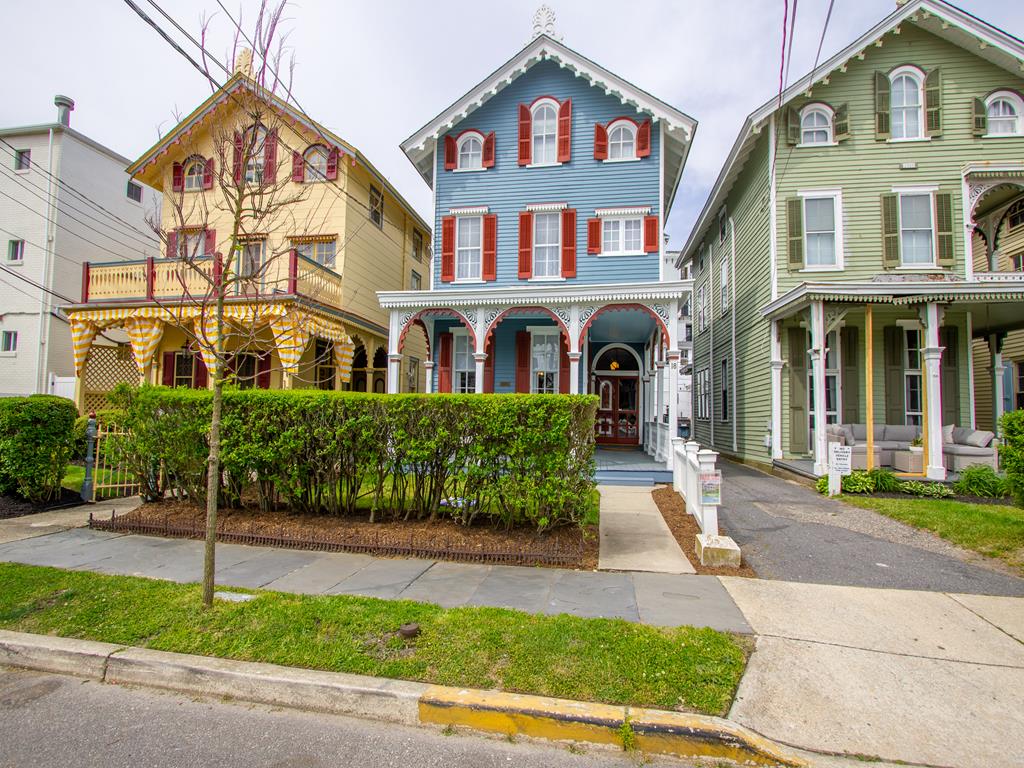 image This stunning Victorian gingerbread house is located just a half block from the beach in the Historic District, featuring charming porch seating and spacious accommodations for large groups.
